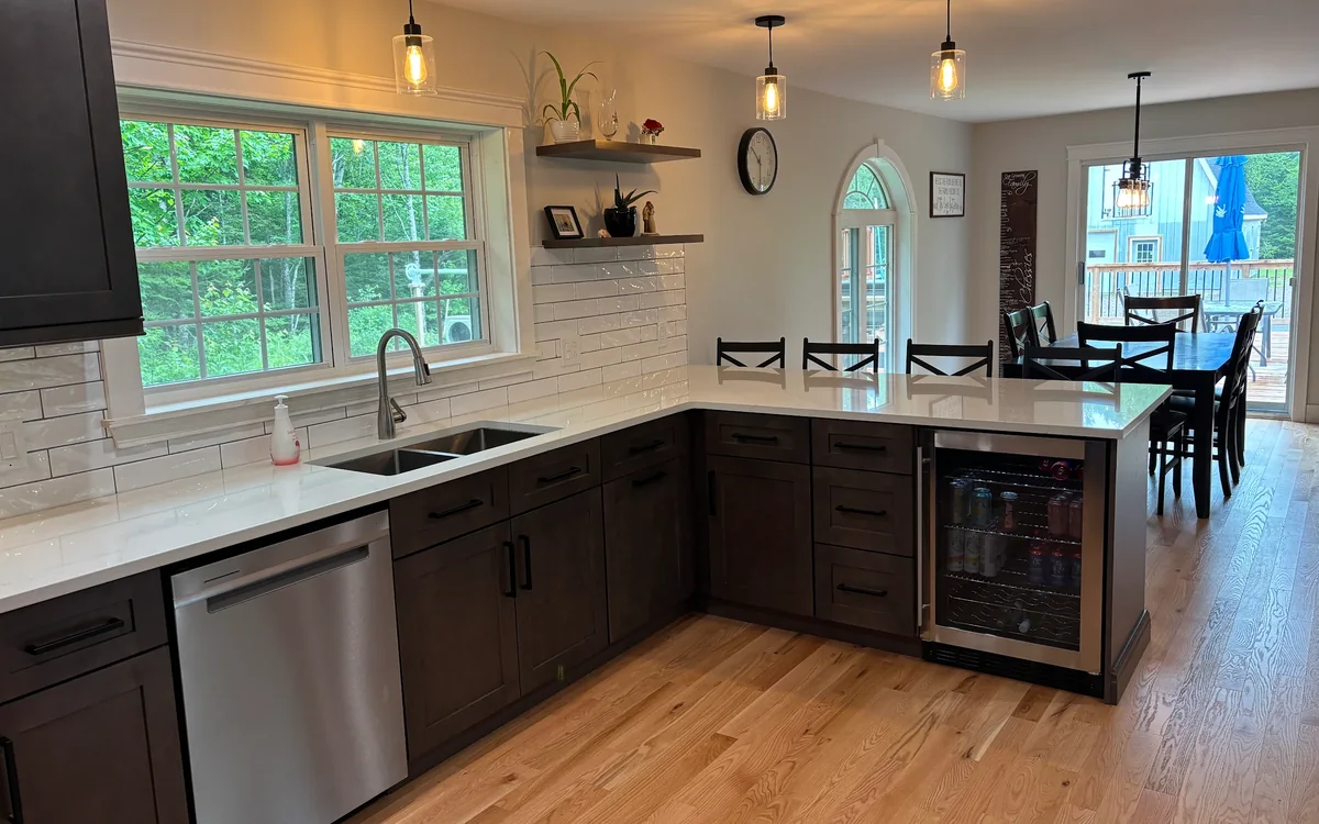 Finished Graphite Shaker kitchen with a peninsula and seating in Harvey, NB by BluePrint Cabinets.
