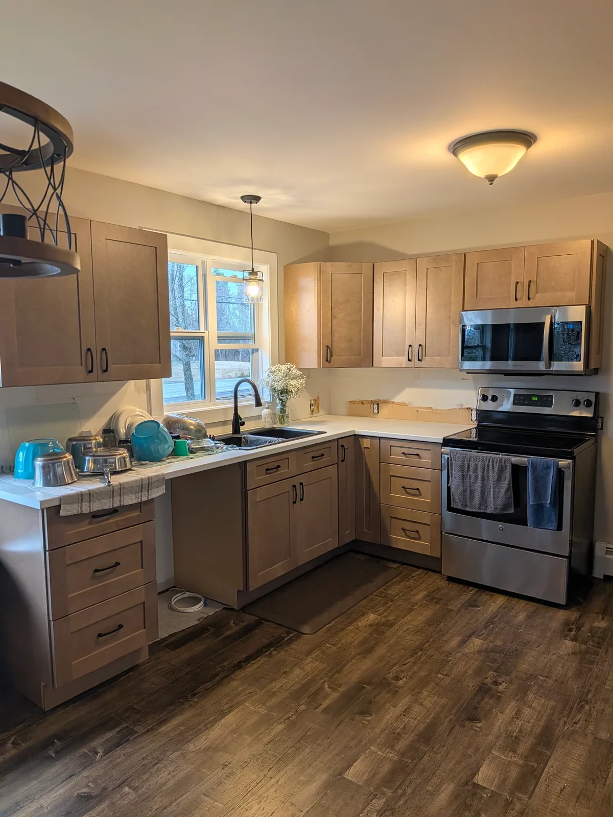 Finished shaker kitchen cabinets with black hardware